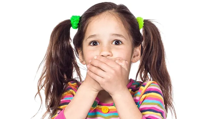 Smiling child showing early orthodontic treatment